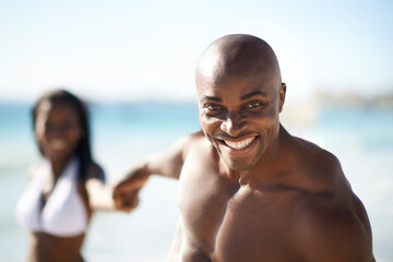 Portrait of black couple on beach, holding hands and smile on holiday with sunshine, tropical...