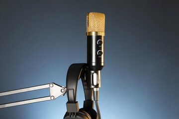 Stand with microphone and headphones on dark background. Sound recording and reinforcement