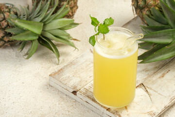 pineapple juice in glass on white table
