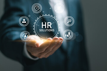 HR Solutions concept. Businessman holding human resources solutions icons for human resources...