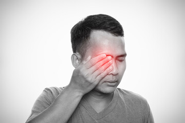 Man suffering from strong eye pain. Isolated on white background. Healthcare and health problem...