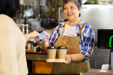 Asian senior people lifestyle small business start-up show credit card cashless payment by...
