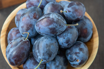 Plum variety Hungarian. Fruit harvest on the table in the kitchen. Autumn blue plum. Vitamin food bowl.