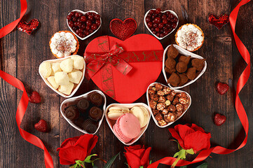 Gourmet heart shaped chocolate candies, sugar cranberry, meringue and rose flowers, food for Valentine's Day or Women's Day, greeting card, advertising banner or store invitation,