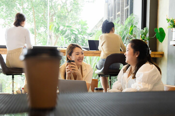 Asian young barista worker female holding Promotion sign board and bread in basket in front of bakery cabinet taking pictures to promote in social media channel, happy small business owner lifestyle