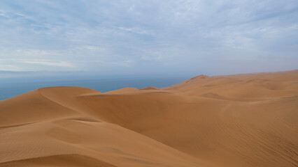 Scenic panoramic view of the giant dunes at Sandwich Harbour, Walvis Bay, Namibia