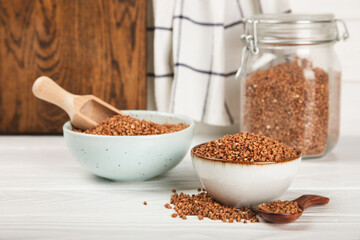 Raw buckwheat in a bowl on a textured background.Wheat grains, porridge, cereals, raw buckwheat in a plate. Healthy food. Porridge. Diet. Organic cerea. Space for text.Copy space.
