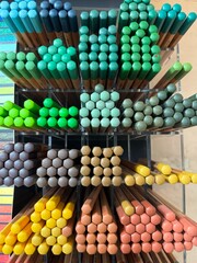 Shelf with colorful pencils for drawing and graphic arts. Drawing education background.