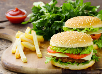 traditional cheeseburger with salad and french fries