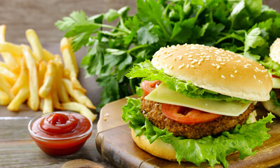 traditional cheeseburger with salad and french fries