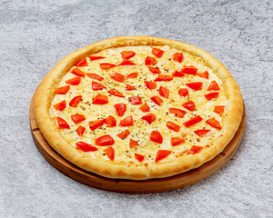 Homemade New York style pizza with mozzarella cheese and tomato close-up on a wooden board on the table. Horizontal 