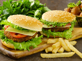 traditional cheeseburger with salad and french fries