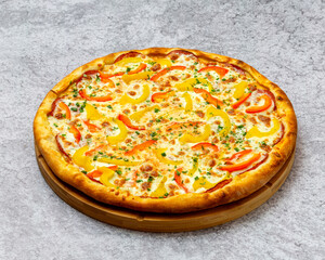 Homemade Italian style pizza with cheese, yellow and red peppers close-up on a wooden board on the table. Horizontal