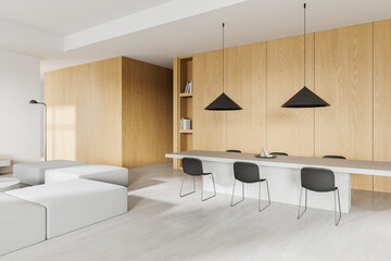 White and wooden dining room interior with sofa