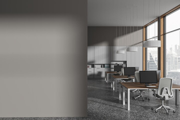 Modern gray office with blank wall