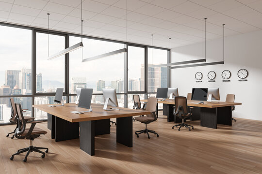 Modern office interior with pc monitors, world clock and panoramic window