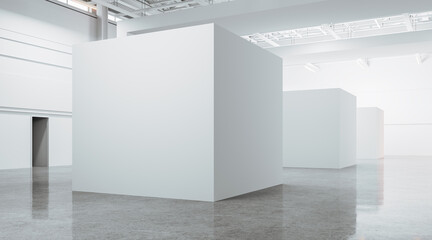 Open space large gallery interior with blank white boxes on concrete floor