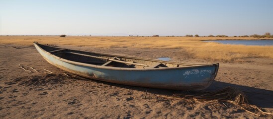 A deserted Mashoof canoe left on Iraq's parched southern marshes due to a severe summer drought caused by climate change and political unrest.