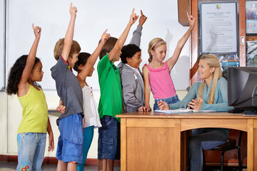 Teacher woman, classroom and children with raised hand for question, answer or pop quiz for knowledge. Teaching person, school kids and education for development, scholarship or assessment at academy - obrazy, fototapety, plakaty