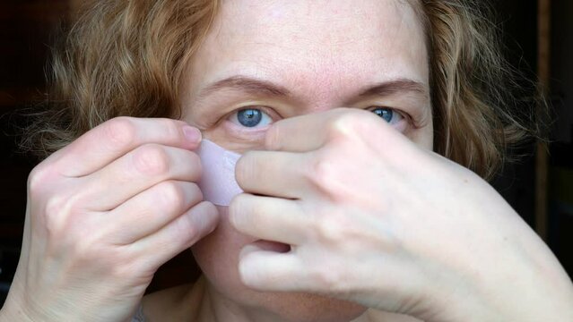 middle aged female's eye with drooping eyelid with patch for eyes. Ptosis is a drooping of the upper eyelid, lazy eye. Cosmetology and facial