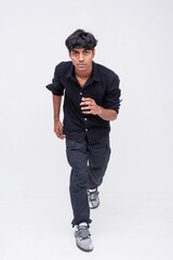 Confident Young indian man Walking Forward in Casual Wear. Stylish male model posing and running on white background