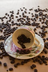 cup of hot coffee with coffee beans in the background