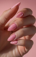 elegant nail design. a woman's hand with a pink manicure in close-up.