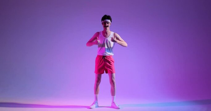 Retro dance party with stylish man expresses approval with a thumbs up gesture, seamlessly transitioning into lively dance moves against a purple background.