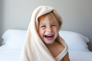 Fototapeta na wymiar Joyful Infant Wrapped in Towel