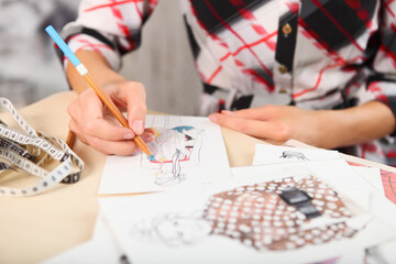 Dressmaker is drawing a fashion sketch - Powered by Adobe