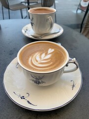 A cup of cortado coffee served in an elegant cup and saucer on an outdoor terrace