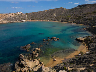 Ghajn Tuffieha Bay Malta Riviera beach with beautiful rock formation in turquoise sea and sandy...