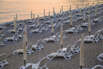 Beach in the evening at sunset with closed umbrellas in Montenegro.