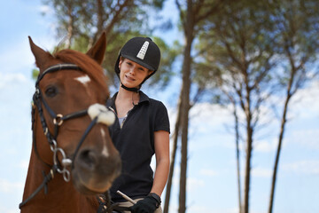 Obraz premium Equestrian, portrait and riding a horse in nature on adventure, journey and happiness in countryside. Ranch, animal and rider outdoor with hobby, sport and pet on farm with girl on blue sky in summer