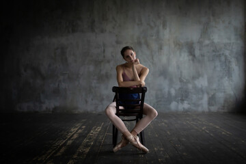 Portrait of a ballerina sitting on a chair. © dimedrol68