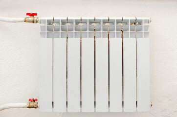 White metal heating radiator forming part of a central heating system with energy-efficient thermal...