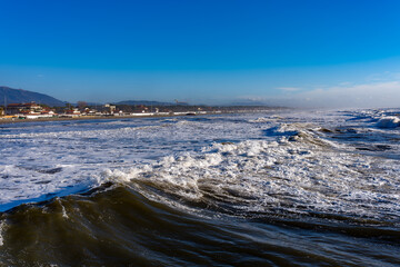 Fototapeta premium Seascape on a day with very rough seas in the background the beach and the town of Forte dei Marmi Tuscany Italy