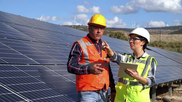 Solar panels, handshake and people partnership, collaboration or thank you for installation of green energy power. Young adult engineer inspect installation of solar panels installed. - Powered by Adobe