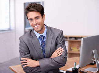 Portrait of happy businessman at desk with smile, arms crossed and career in legal inspection at law firm. Confident attorney, lawyer or business man with office job as quality assurance professional
