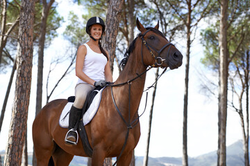 Portrait, horse riding or happy woman in woods or forest with rider or jockey for recreation or...