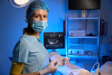 Fotobehang Female doctor using syringe for artificial fertilization in reproductive clinic © Svitlana