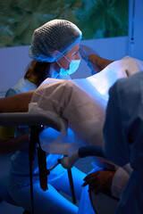 Female doctor doing embryo transfer for partial woman patient