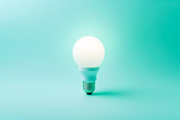 Economical white Led lightening lamp stands on tender blue background. Eco power and power saving concept