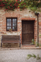 Tuscany old wooden door in a brick wall