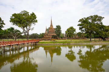Fototapeta na wymiar Wat Sa Si temple and wooden bridge, Shukhothai Historical Park, Thailand, one of UNESCO Heritage Site