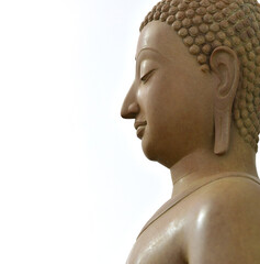 Close-up of the face of a brown stone Buddha in Buddhism, white background.
