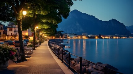 City of Riva del Garda by Garda lake in Italy. View from the promenade to see in the early morning - obrazy, fototapety, plakaty