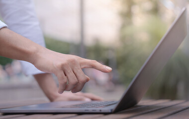 Businessman in casual look using laptop and working in startup business at cafe coffees shop in public locations ,work from home and anywhere meeting online, searching internet for job in social media