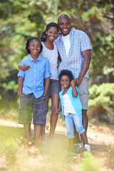 Happy, portrait or black family hiking in forest to relax or bond on holiday vacation together in...