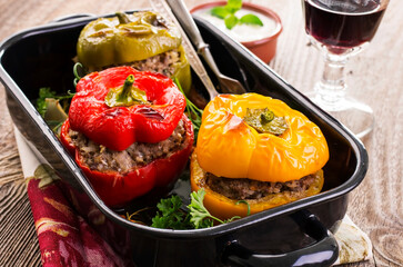 Traditional German stuffed bell peppers with minced meat served as close-up on a classic design backing pan